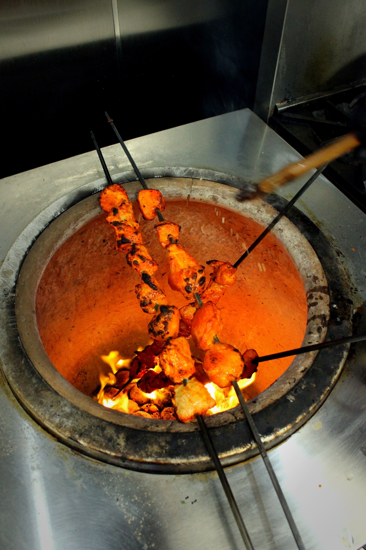 Paneer tikka roasting in the tandoor at MangoLeaf